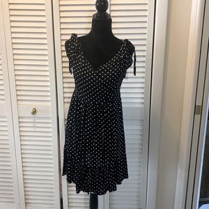 Flirty black polka dot tie strap mini dress .